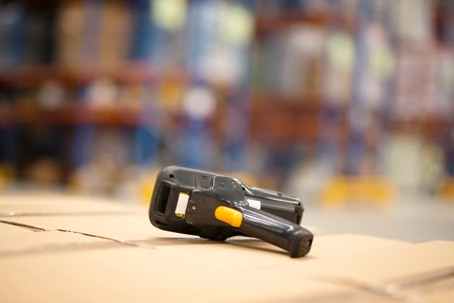 close-up-view-bar-code-scanner-placed-cardboard-boxes-large-distribution-warehouse-facility_342744-1551